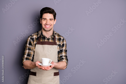 Photo of trendy cheerful fun positive barista serving you cup of tea giving stretching hands to deliver isolated grey color background