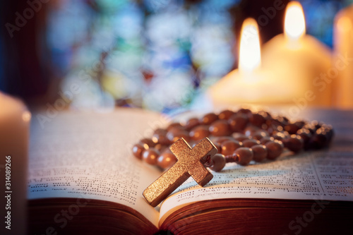 Rosary beads and crucifix cross on holy bible photo