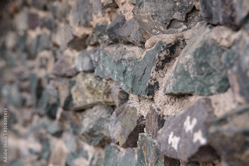 Texture: a wall of folded natural stone, reinforced with a small amount of cement. Texture: a wall of folded natural stone, reinforced with a small amount of cement.