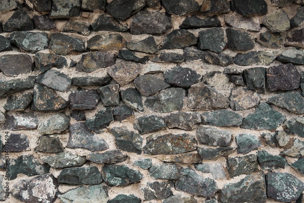 Texture: a wall of folded natural stone, reinforced with a small amount of cement. Texture: a wall of folded natural stone, reinforced with a small amount of cement.