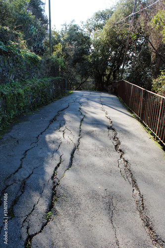 Sentiero asfaltato con moto franoso photo