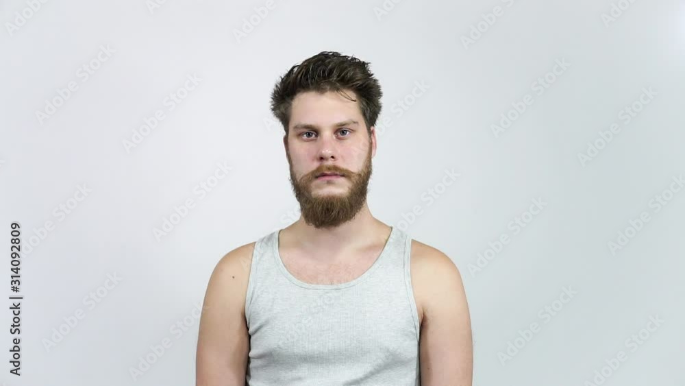 Frustrated man looking at the camera.A young guy with a beard in depression. Frustrated man looking at the camera.A young guy with a beard in depression.