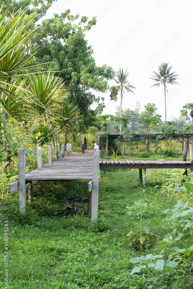 Old wooden bridge on green grass lawn. Old wooden bridge on green grass lawn.