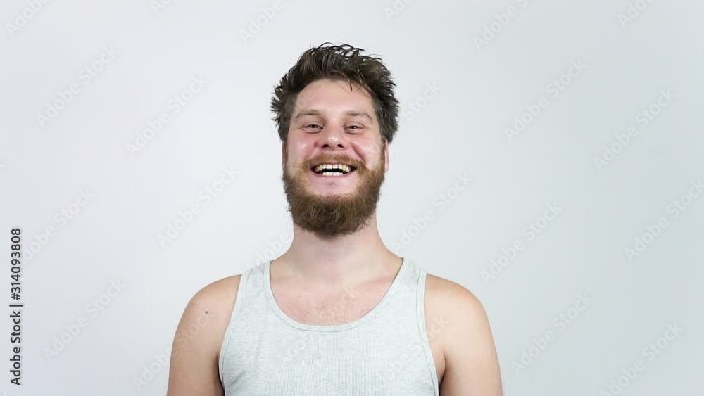 A charismatic man laughs happily at the camera. Close-up of a happy man A charismatic man laughs happily at the camera. Close-up of a happy man