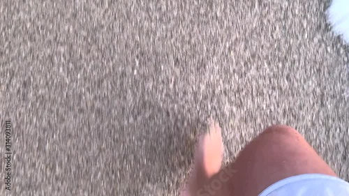 Walking on the beach sand with sea waves. First person video. Summer vacation concept. 4k 60 fps