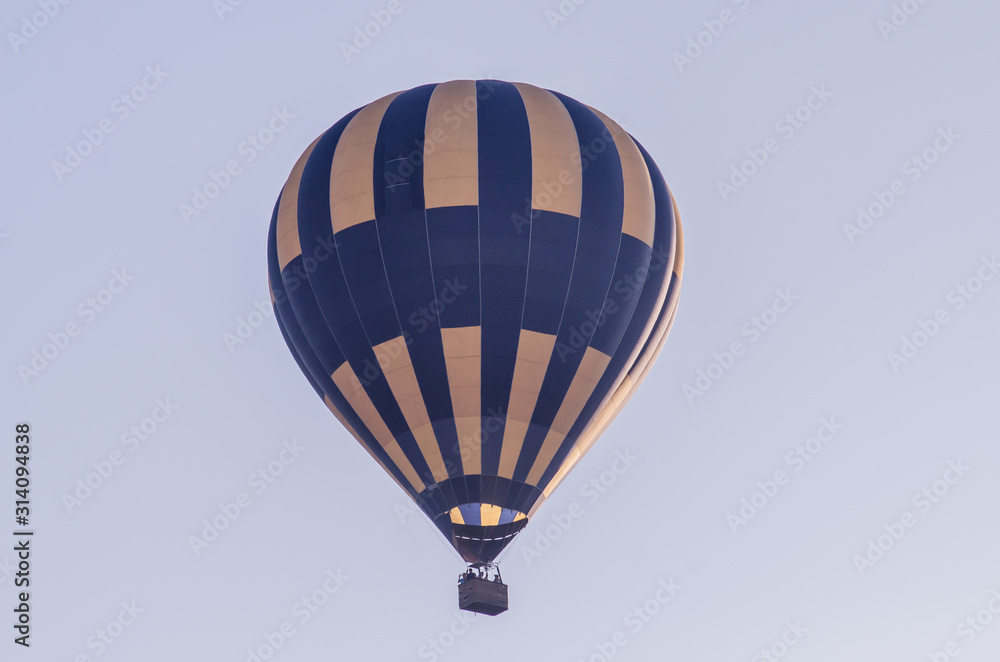 Fototapeta premium hot air balloon is flying at sunrise. romantic balloon flights