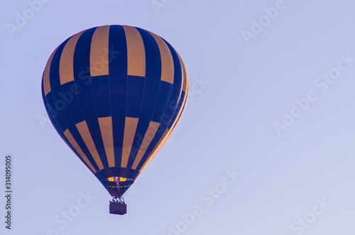 hot air balloon is flying at sunrise. romantic balloon flights