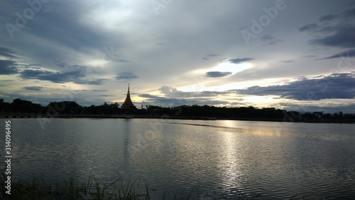 Sky and cloud to show power of natural around lake in the evening and pagoda. © NichameeLifestyle