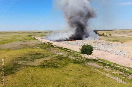 Burning trash. fire at the landfill. Burning garbage.