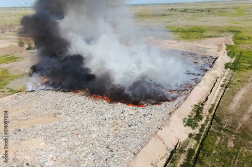 Burning trash. fire at the landfill. Burning garbage.