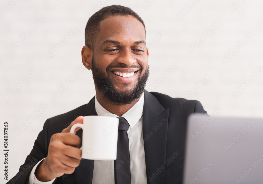 Portrait of smiling black businessman holding coffee mug Portrait of smiling black businessman holding coffee mug