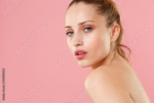 Close up blonde half naked woman 20s perfect skin nude make up blue eyes isolated on pastel pink wall background studio portrait. Skin care healthcare cosmetic procedures concept. Mock up copy space.