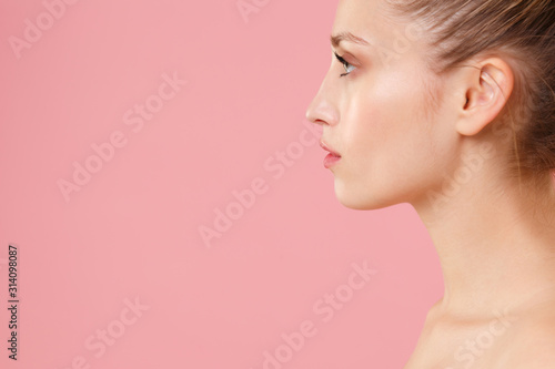 Close up blonde half naked woman 20s perfect skin nude make up blue eyes isolated on pastel pink wall background studio portrait. Skin care healthcare cosmetic procedures concept. Mock up copy space.