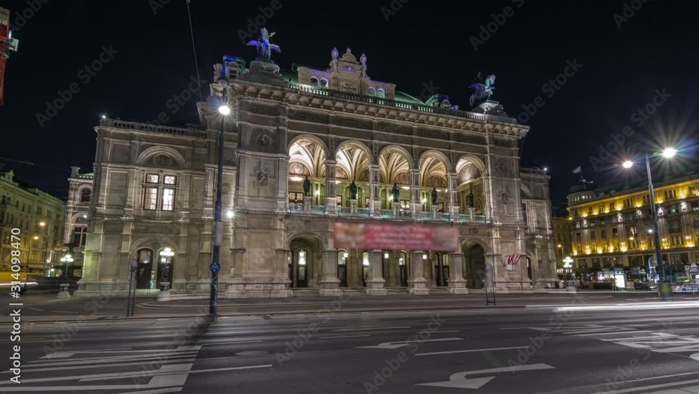 Beautiful view of Wiener Staatsoper (Vienna State Opera) night timelapse hyperlapse in Vienna, Austria. Illuminated historic buildings and traffic on streets Beautiful view of Wiener Staatsoper (Vienna State Opera) night timelapse hyperlapse in Vienna, Austria. Illuminated historic buildings and traffic on streets