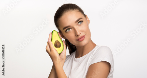 Beautiful Lady Holding Avocado Near Face On White Background, Panorama photo