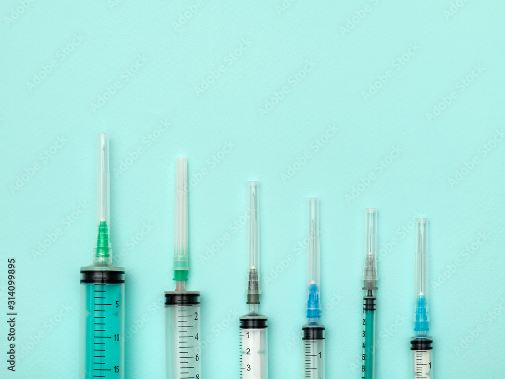Set of medical syringes on colorful background Set of medical syringes on colorful background