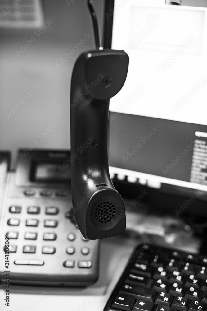 handset on the background of the telephone and monitor with a shallow depth of field handset on the background of the telephone and monitor with a shallow depth of field