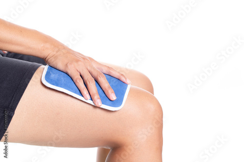 woman putting an ice pack on her leg pain