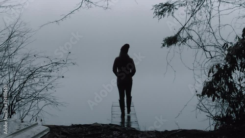 Person Walking in the Cold Weather Outside toward Misty Lake