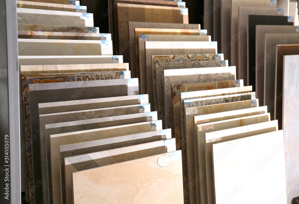 Various ceramic tile samples in store. Total wholesale - obrazy, fototapety, plakaty 