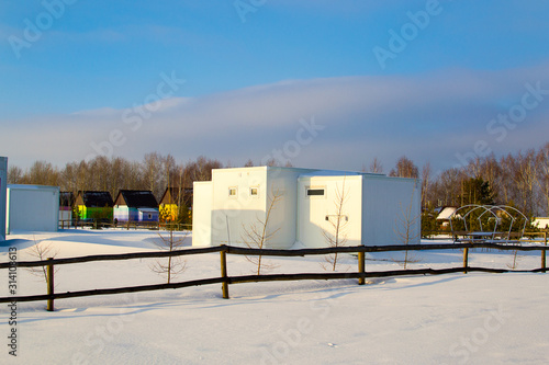 Beautiful houses in the winter recreation Park. Prefabricated houses made of sandwich panels. Frame construction