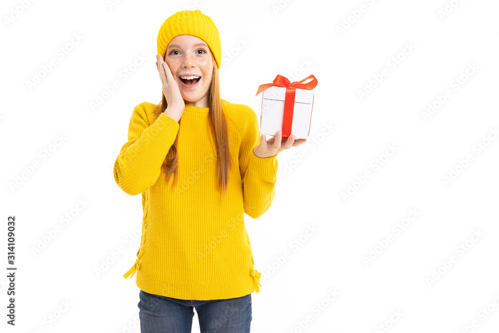 happy red-haired girl with a box tied with a ribbon on a white background happy red-haired girl with a box tied with a ribbon on a white background