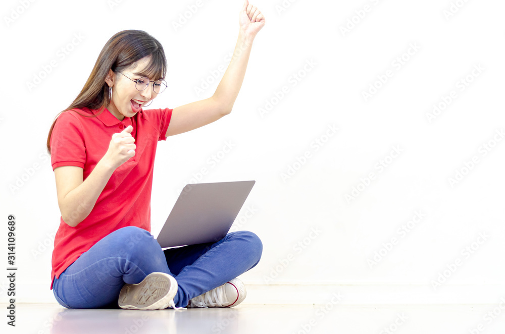 A beautiful Asian woman wearing a red shirt, eyeglasses, smiling with a notebook computer. A beautiful Asian woman wearing a red shirt, eyeglasses, smiling with a notebook computer.
