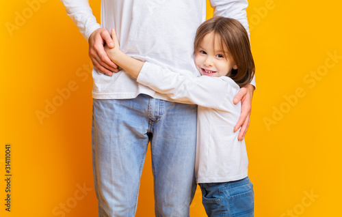 Cute smiling preschool girl hugging her daddy