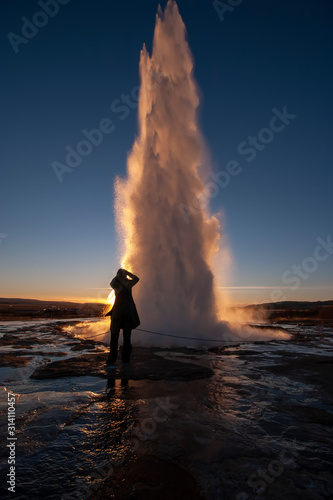 woman standing at Icelandic geysir