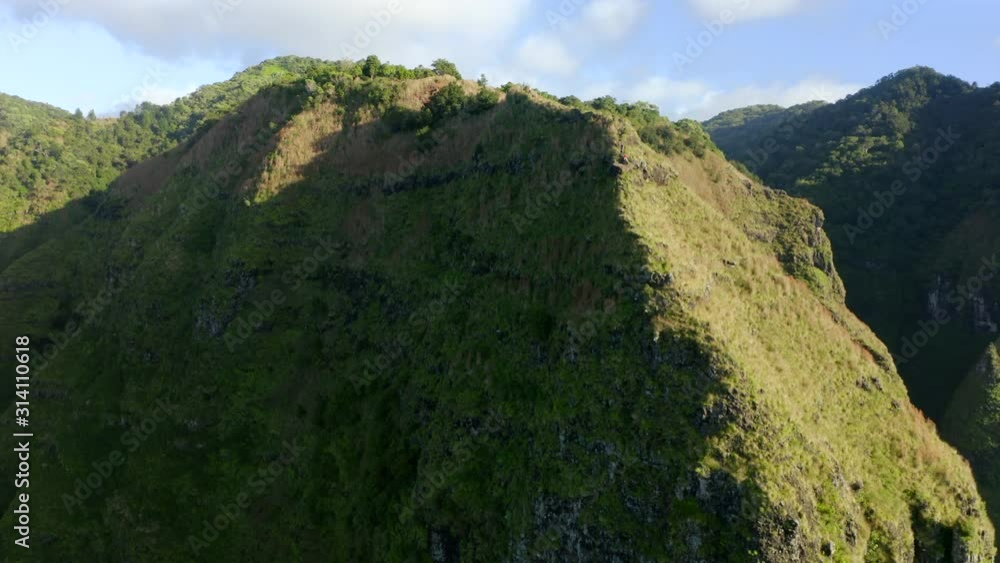 Smooth drone flight over sharp mountain edge towards the top of big mountain covered with lush bushes and grass.The scenery is lit with sun. Bright blue sky with clouds over the landscape. Aerial, 4K Smooth drone flight over sharp mountain edge towards the top of big mountain covered with lush bushes and grass.The scenery is lit with sun. Bright blue sky with clouds over the landscape. Aerial, 4K