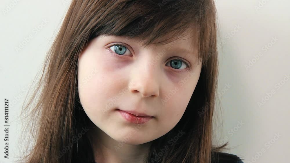 Close up portrait of beautiful girl with blue eyes on white background