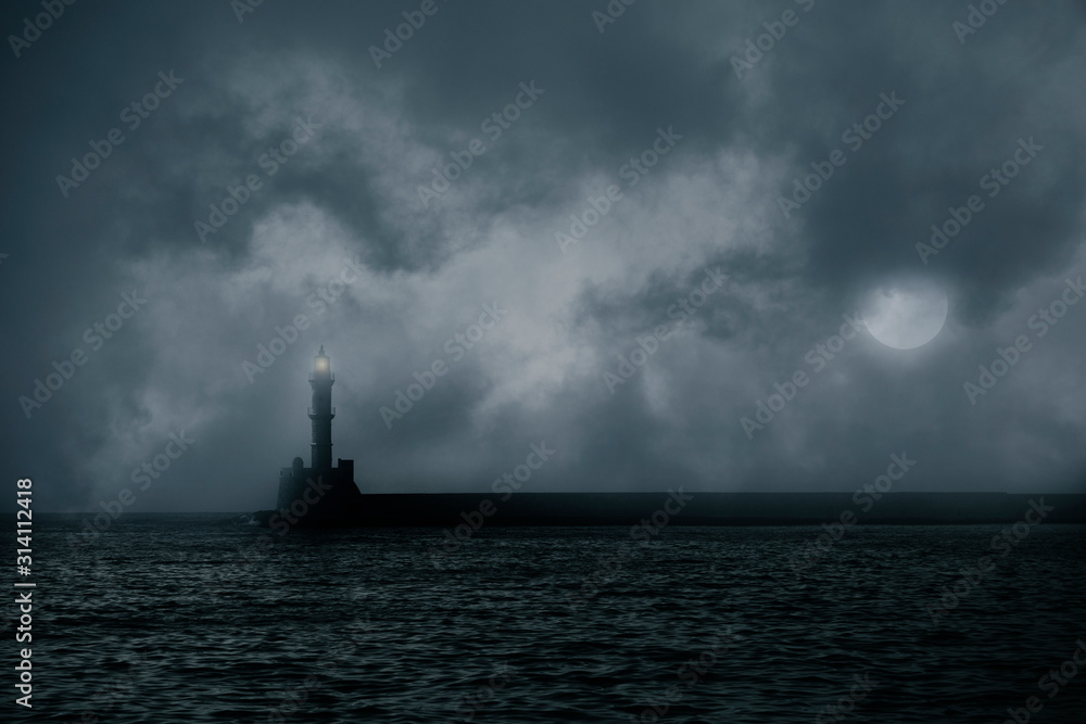 Lonely lighthouse on stormy sea against dark clouds
