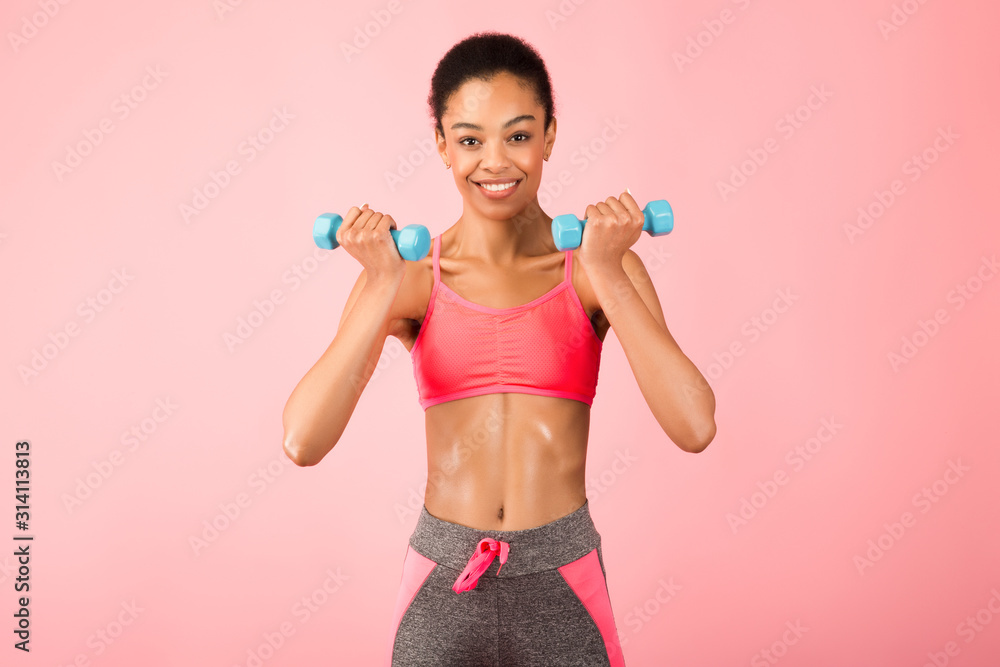 Smiling Afro Girl Doing Dumbbell Biceps Curl Exercise, Studio Shot Smiling Afro Girl Doing Dumbbell Biceps Curl Exercise, Studio Shot