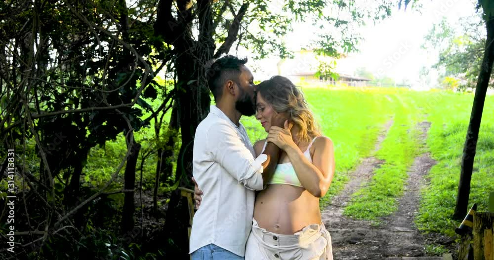 Happy husband with his wife's pregnancy, kissing her forehead, happy waiting for the baby. Happy husband with his wife's pregnancy, kissing her forehead, happy waiting for the baby.