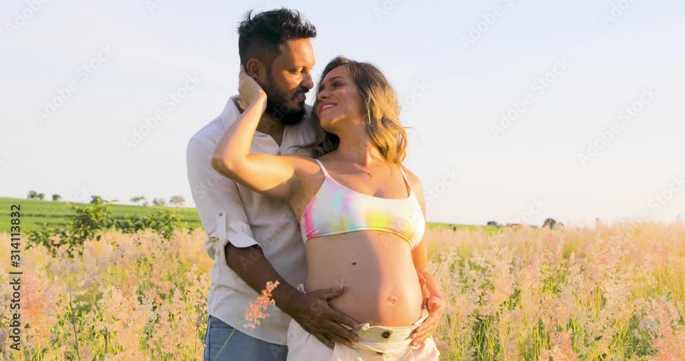 First-time parents exchanging caresses in the midst of nature, waiting for a new life that will totally change theirs. First-time parents exchanging caresses in the midst of nature, waiting for a new life that will totally change theirs.