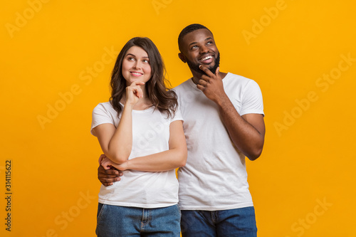 Portrait of pensive young interracial couple thinking about something