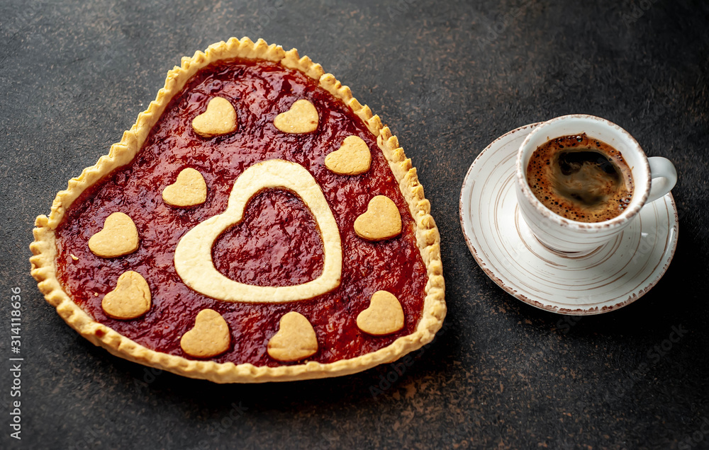 coffee, heart-shaped cake, a gift with a red ribbon for Valentine's Day on stone background, with copy space for your text. breakfast concept on saint's day Valentine. coffee, heart-shaped cake, a gift with a red ribbon for Valentine's Day on stone background, with copy space for your text. breakfast concept on saint's day Valentine.