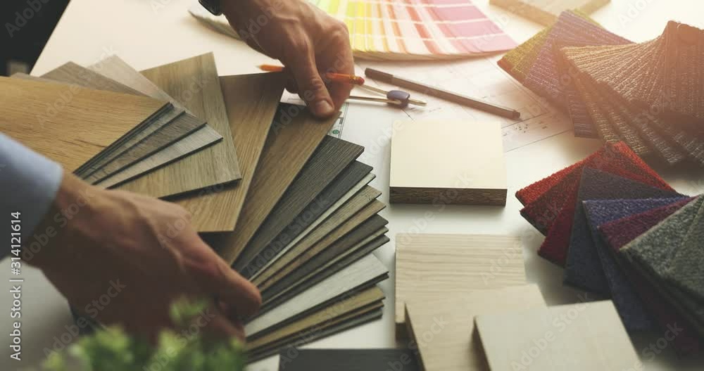 interior designer choosing flooring and furniture materials from ...