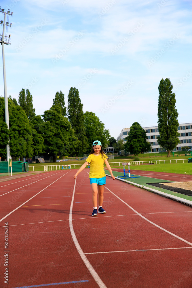 Little girl have fun on the stadium