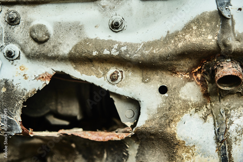 Details of old car. Aged oldtimer vintage automobile. Spare parts of retro classic automobile. Disassembled car in a parking lot.