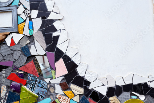 Colorful texture, wallpaper and background with ceramic pieces and mirror parts over white wall. Unusual design, decoration and exterior or interior details concept