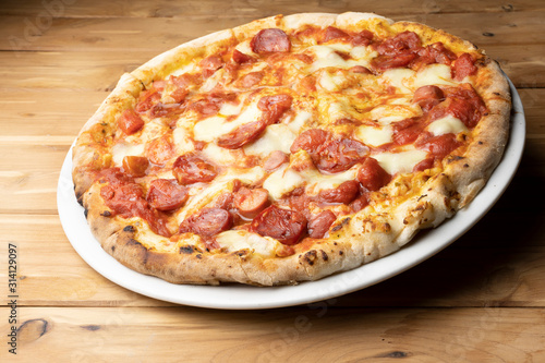 pizza with salami on the wooden table