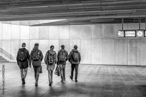 Photography Group of five boys on their way out in a railway station