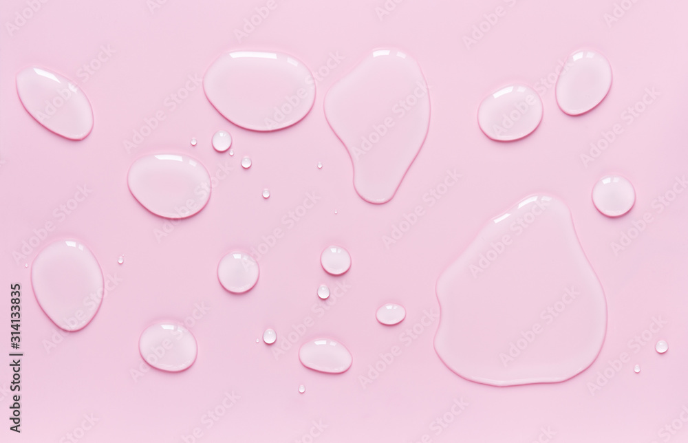 drops of water spilled on a light pink surface