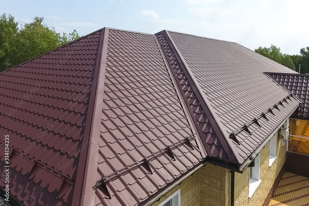 Corrugated metal roof and metal roofing. Modern roof made of met Corrugated metal roof and metal roofing. Modern roof made of met