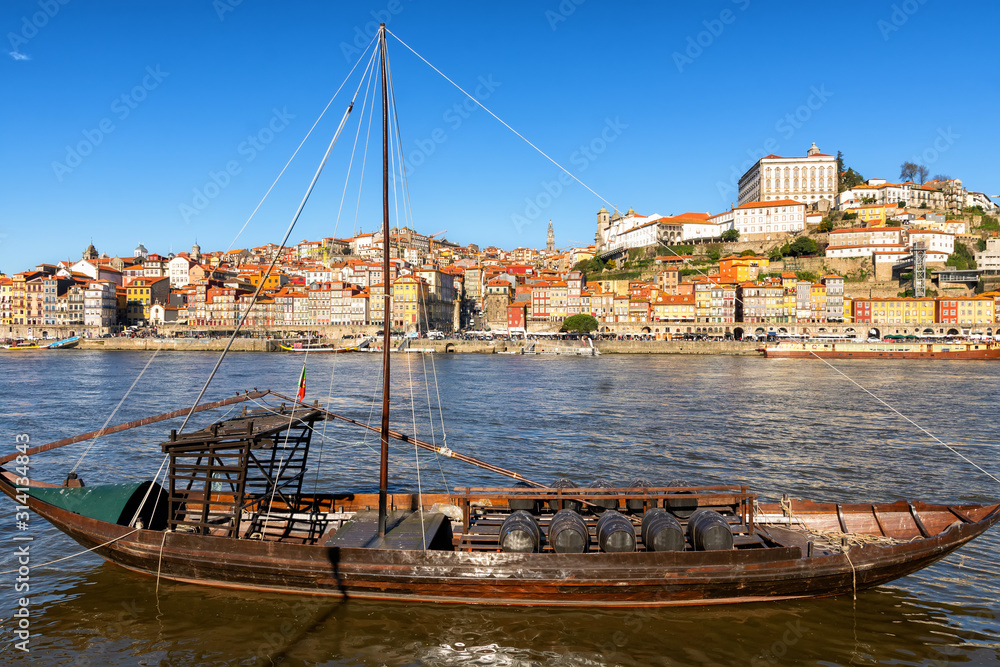  View of Douro River and the city of Porto, large boats with barrels of wine - port