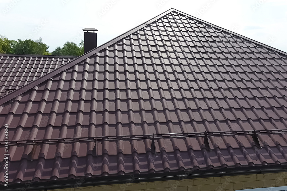 Fototapeta premium Corrugated metal roof and metal roofing. Modern roof made of met