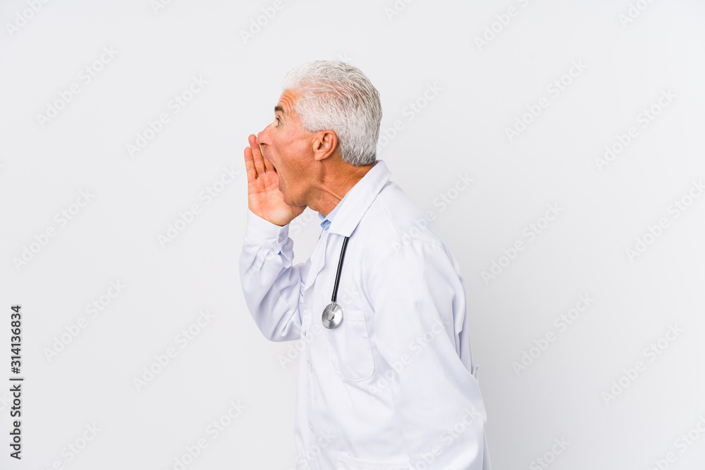 Mature caucasian doctor man shouting and holding palm near opened mouth. Mature caucasian doctor man shouting and holding palm near opened mouth.
