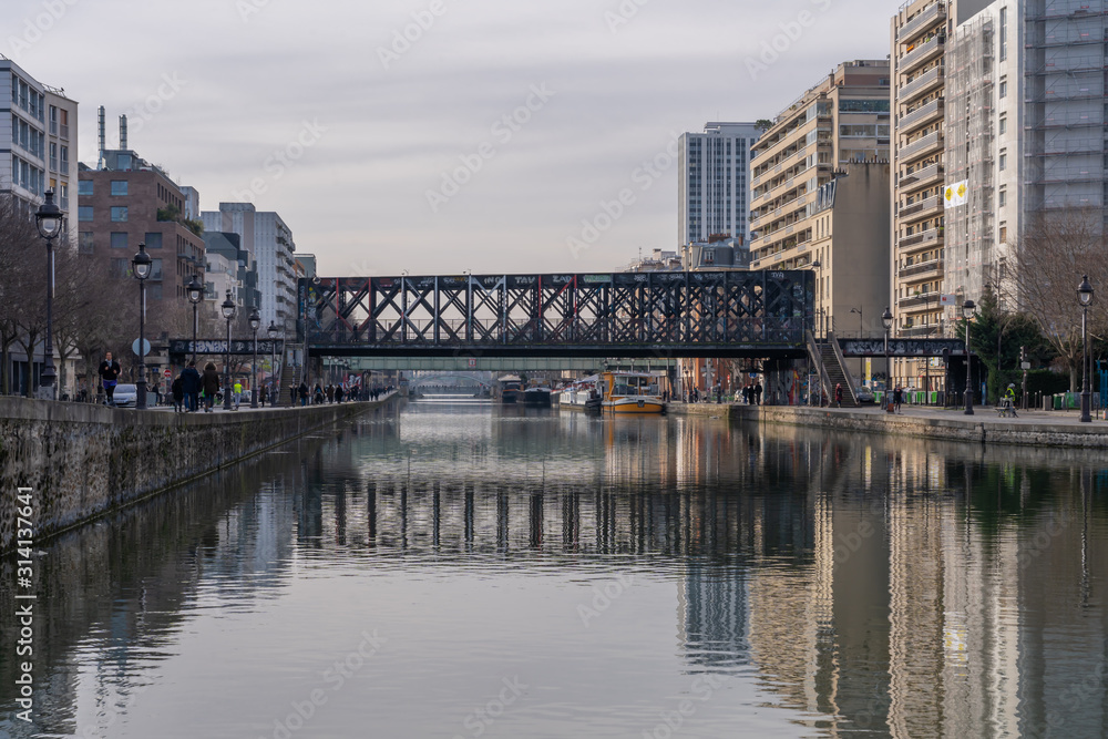 Paris, France - 12 29 2019: Ourcq Canal. Railway bridge