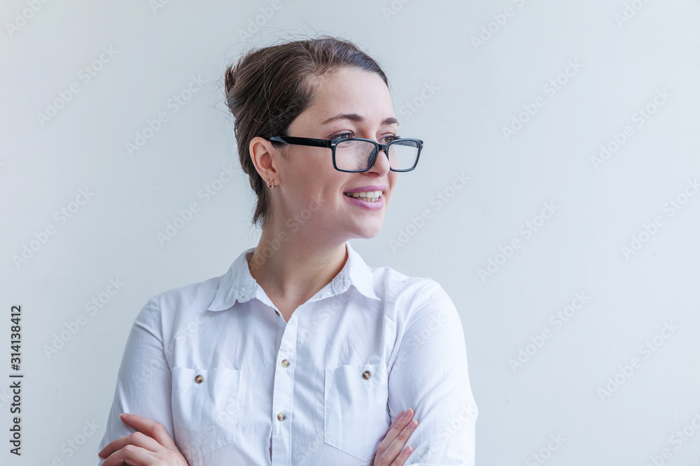 Beautiful happy girl smiling. Beauty simple portrait young smiling brunette woman in eyeglasses isolated on white background. Positive human emotion facial expression body language. Copy space Beautiful happy girl smiling. Beauty simple portrait young smiling brunette woman in eyeglasses isolated on white background. Positive human emotion facial expression body language. Copy space